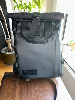 WANDRD PRVKE Lite travel camera backpack black roll-top closure magnetic handles